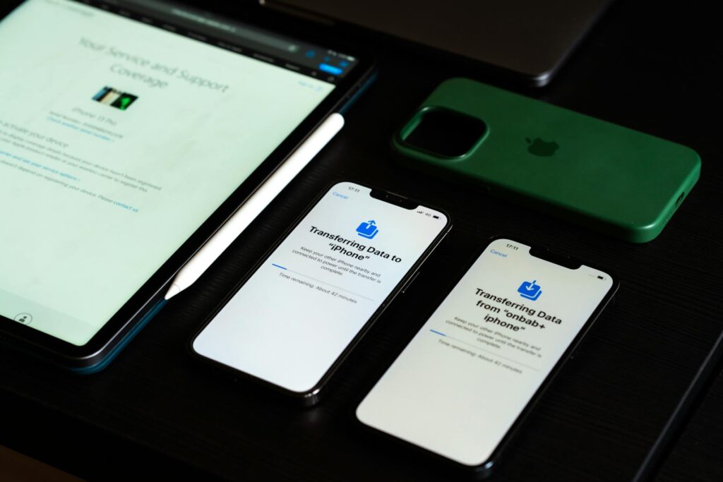 High-angle view of digital devices including iPhones and an iPad on a desk, showcasing data trans... (Photo by Sami  Abdullah on Pexels)