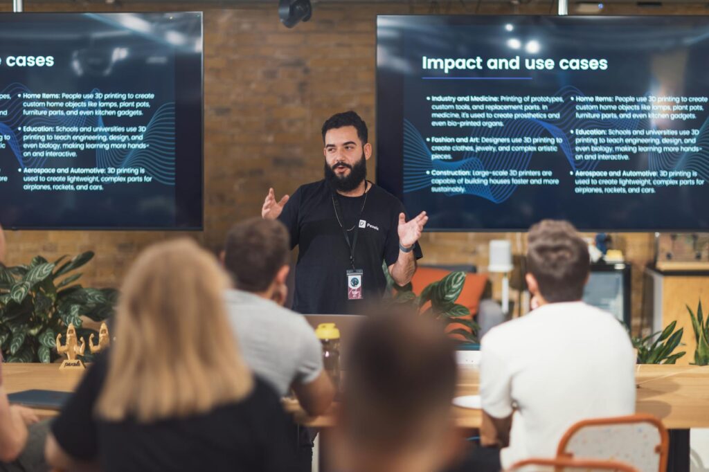 Professional speaker discusses 3D printing applications with attentive audience in tech seminar. (Photo by Matheus Bertelli on Pexels)