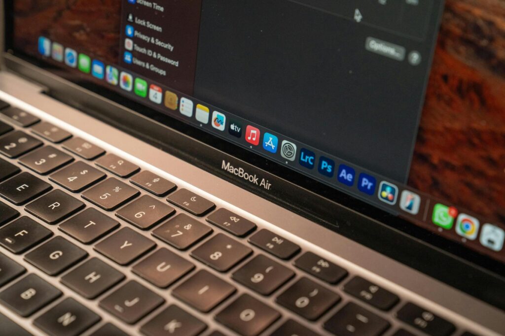A detailed view of a MacBook Air with a focus on the keyboard and screen displaying app icons. (Photo by Guilherme  Pedrosa on Pexels)