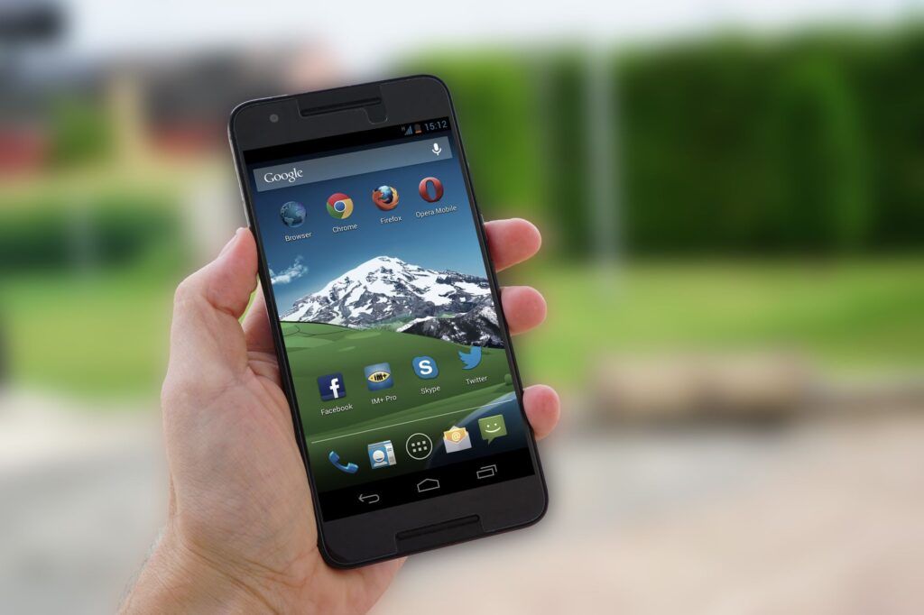 Close-up of a smartphone in hand displaying social media apps on screen. (Photo by Pixabay on Pexels)