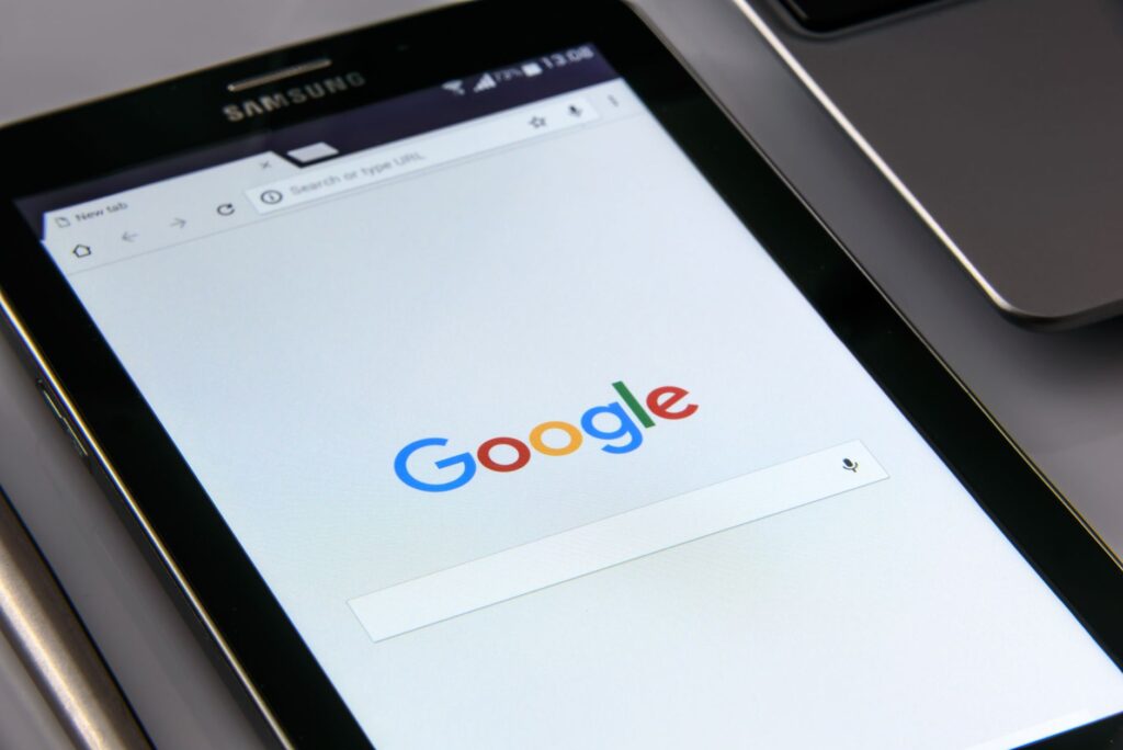 Close-up of a tablet displaying Google's search screen, emphasizing technology and internet brows... (Photo by AS Photography on Pexels)